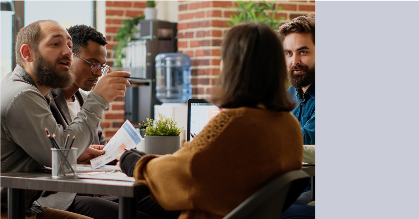 Managers at a table discussing permissions for viewing agent conversations