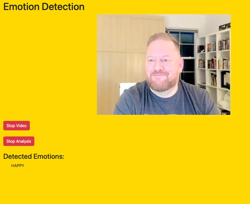 A man is smiling with detected emotion happy displayed on an emotion detection software interface. A man is smiling with detected emotion happy displayed on an emotion detection software interface.