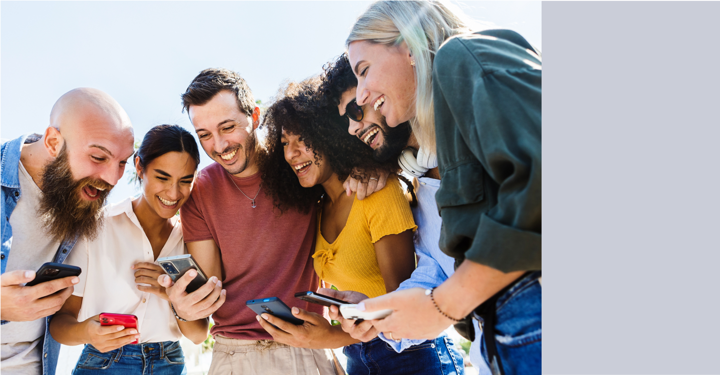 Group of friends gathered around a mobile device