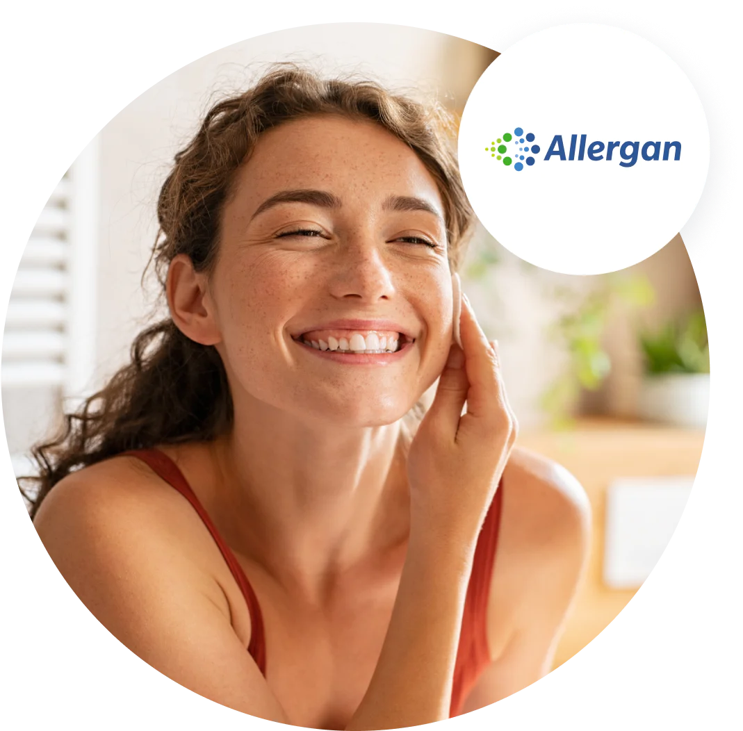 Woman Smiling and Skincare Routine Woman with curly hair smiling and touching her face, Allergan logo in upper right corner