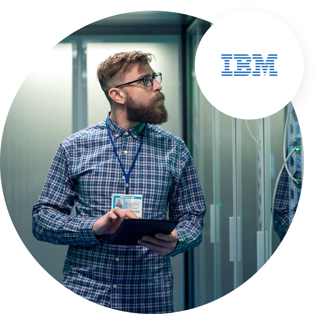 IBM employee working in a data center Man with beard and glasses using tablet in IBM data center