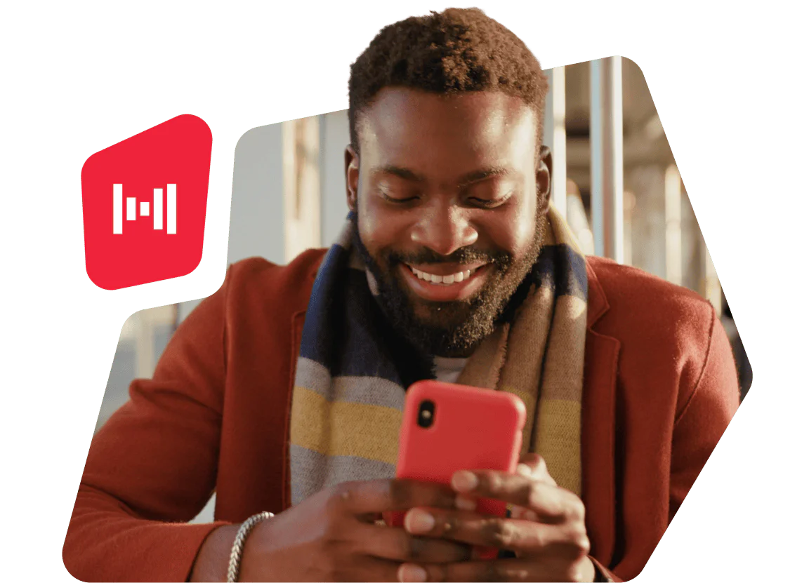 Smiling man wearing a colorful scarf uses a red smartphone with a red icon overlay on the left.