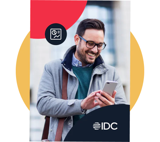 Man Smiling While Using Smartphone in Business Attire Man wearing glasses and coat, smiling at his smartphone