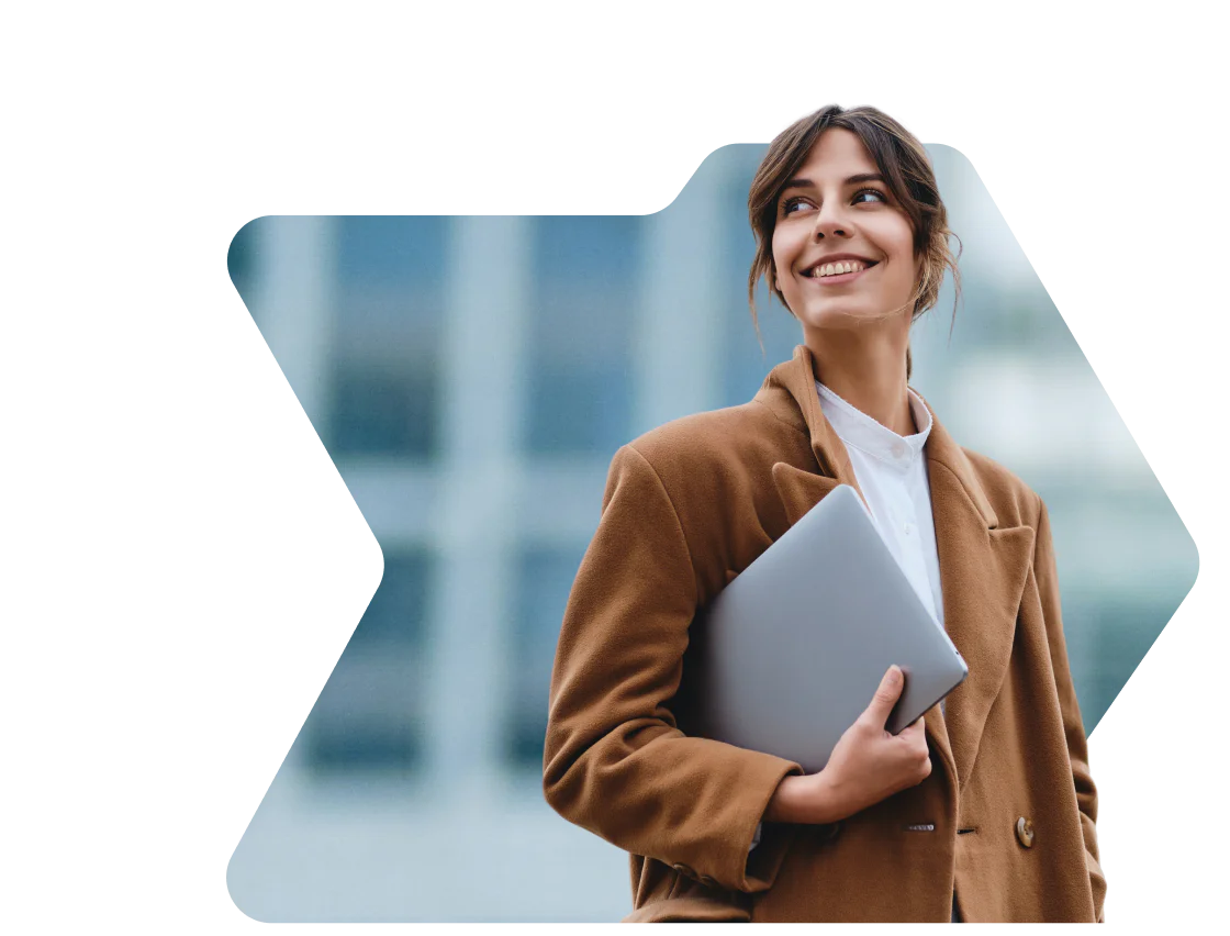 Woman in brown coat smiling and holding a laptop with a birthday discount notification from OWLCLOTHES Woman in brown coat smiling and holding a laptop with a birthday discount notification from OWLCLOTHES
